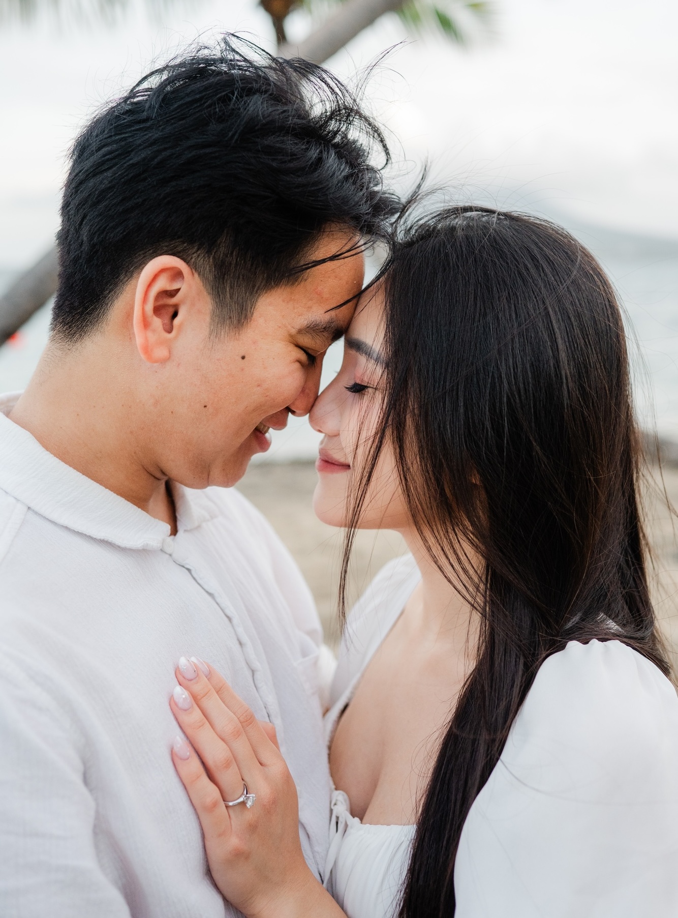 Catherine and Jihan smiling with their foreheads touching